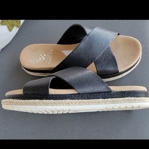 Black slide-on sandals.